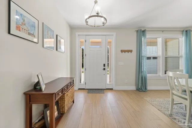 a view of a livingroom with wooden floor and furniture