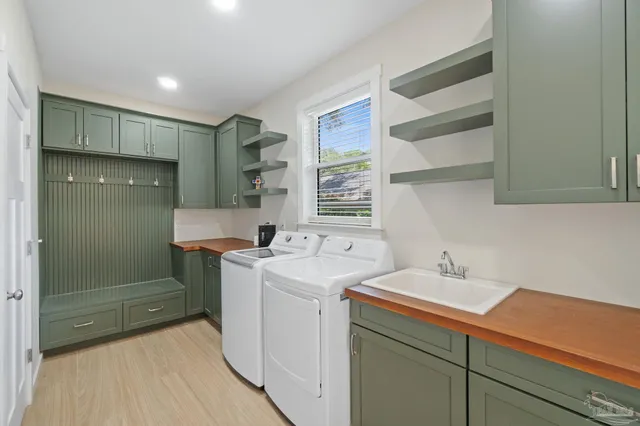 a room with a sink cabinets and utility room