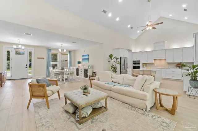 a living room with furniture and kitchen view