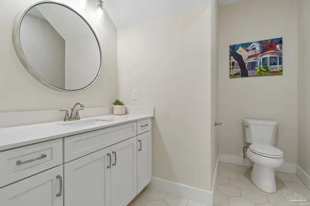 a bathroom with a toilet a sink and a mirror