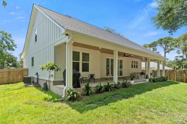 a view of a house with backyard and sitting area