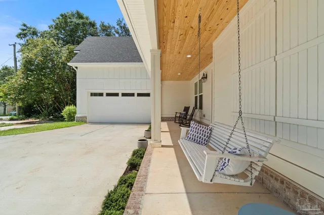 a view of a patio with table and chairs with wooden floor and fence