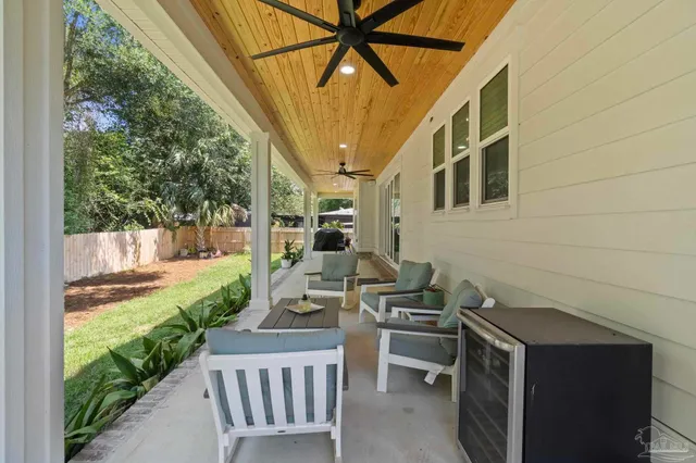 a view of a patio with table and chairs potted plants with wooden floor