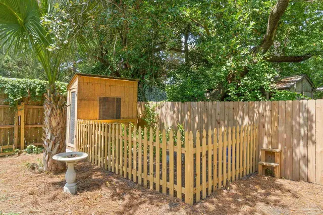 a view of a patio with chairs and potted plants
