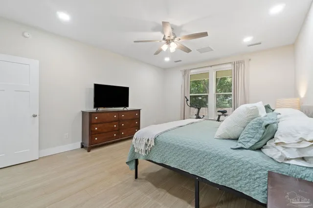 a bedroom with a bed and a tv