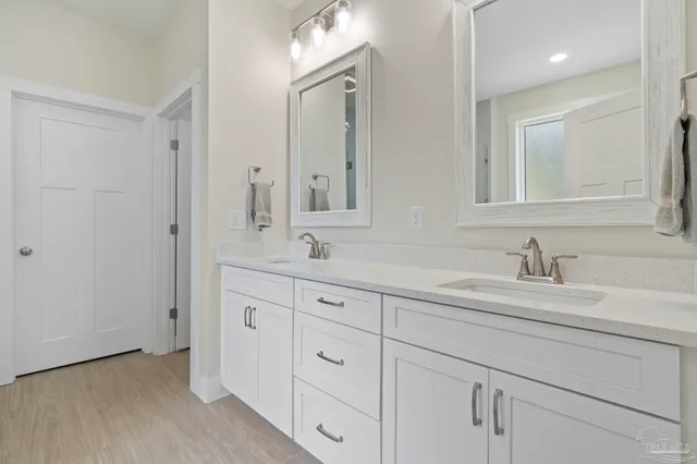 a bathroom with double sink and a mirror