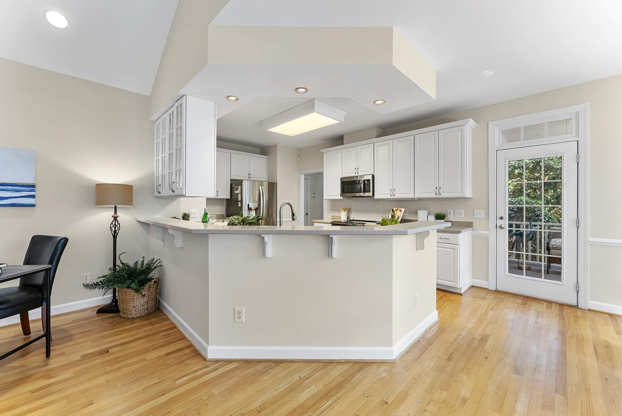 1608 Falls River Avenue Raleigh, NC 27614 - Photo 12 of 65 a view of kitchen with stainless steel appliances granite countertop a stove a sink a refrigerator and white cabinets with wooden floor