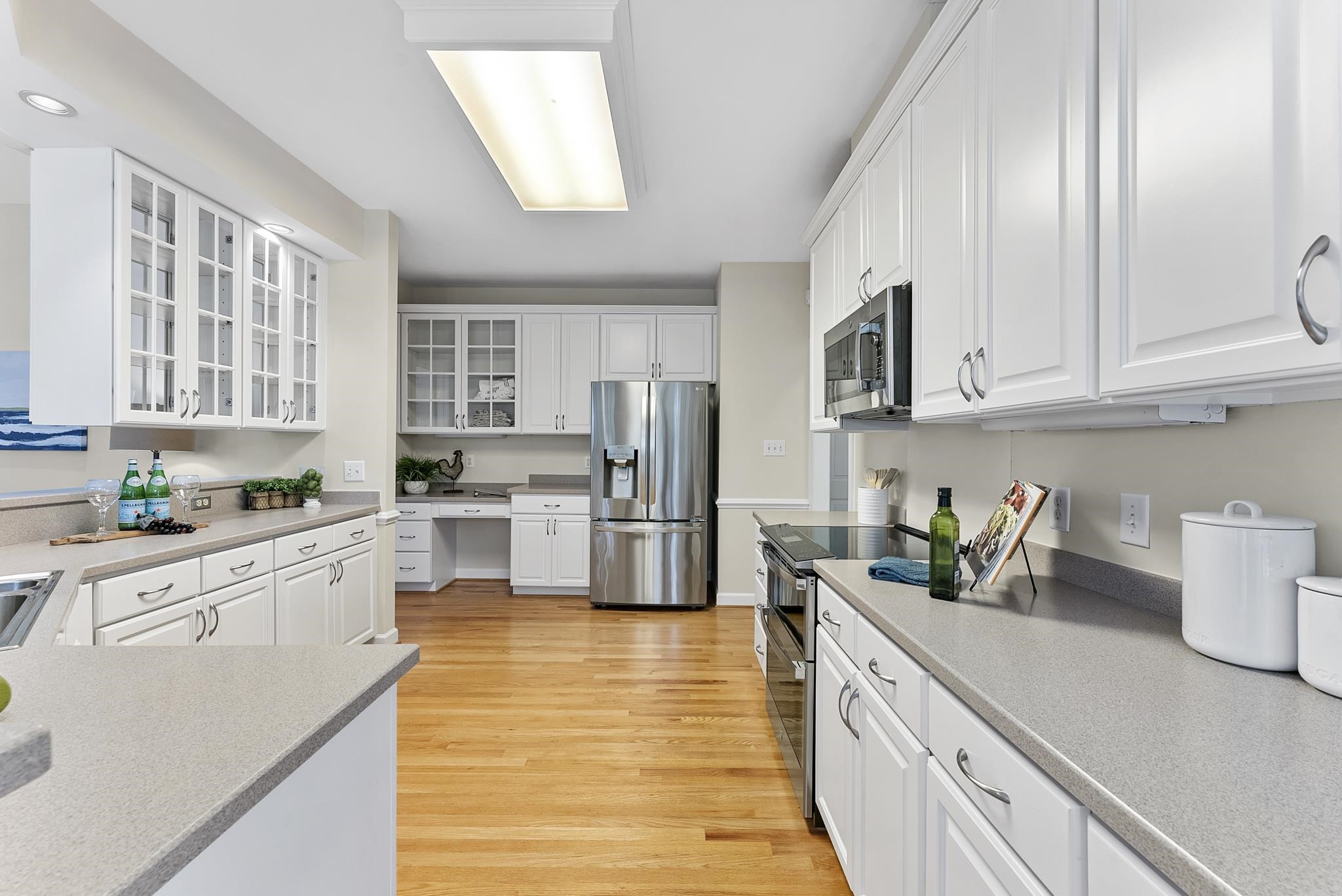 1608 Falls River Avenue Raleigh, NC 27614 - Photo 13 of 65 a kitchen with stainless steel appliances granite countertop a stove a sink and white cabinets