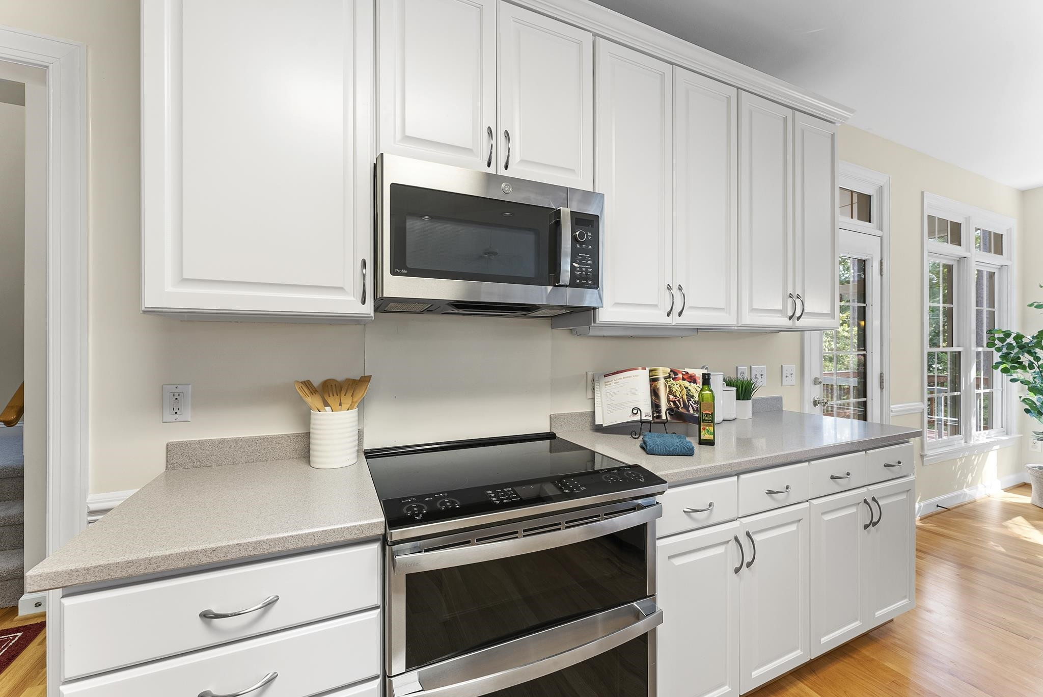 1608 Falls River Avenue Raleigh, NC 27614 - Photo 17 of 65 a kitchen with stainless steel appliances granite countertop a sink a stove and microwave