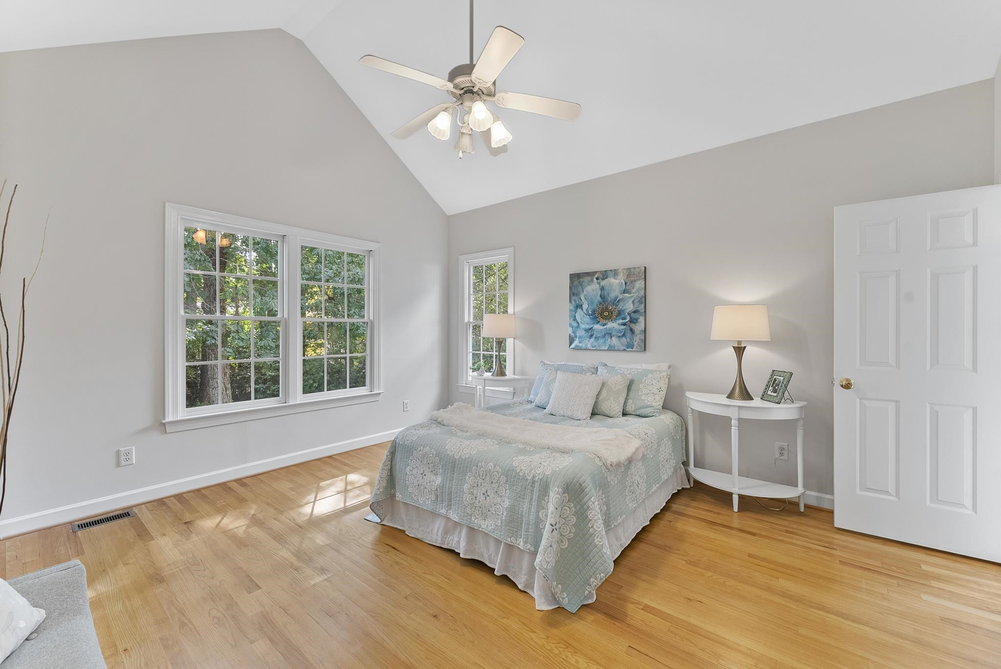 1608 Falls River Avenue Raleigh, NC 27614 - Photo 19 of 65 a bedroom with a large bed a chandelier fan and window