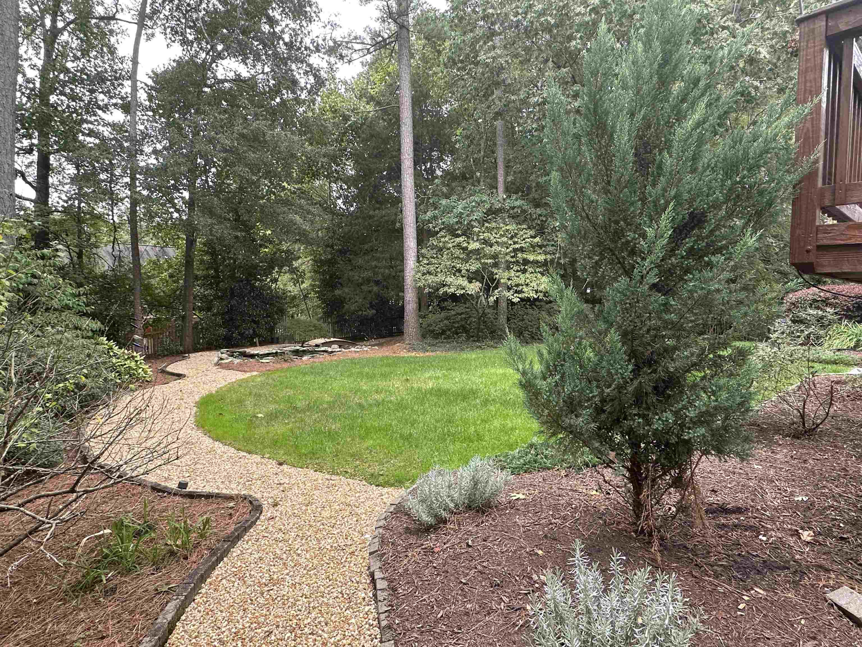 1608 Falls River Avenue Raleigh, NC 27614 - Photo 35 of 65 a view of a backyard with large trees