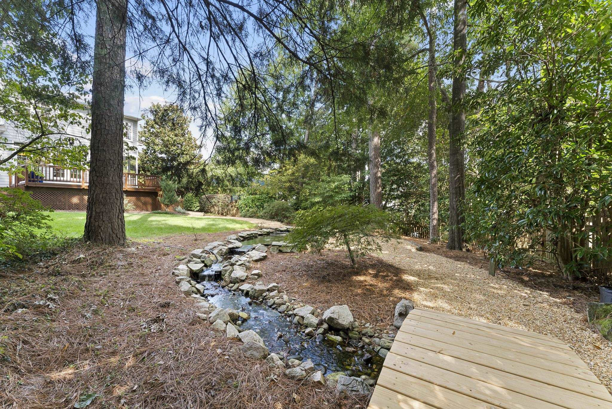 1608 Falls River Avenue Raleigh, NC 27614 - Photo 43 of 65 a view of a yard with plants and trees