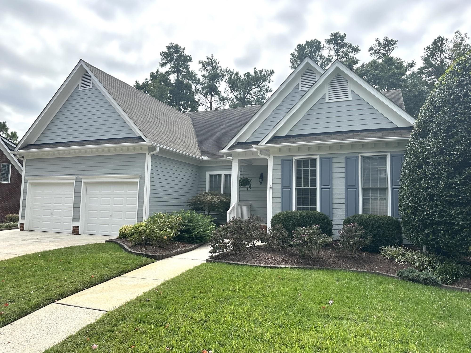 1608 Falls River Avenue Raleigh, NC 27614 - Photo 65 of 65 a front view of a house with a garden and plants