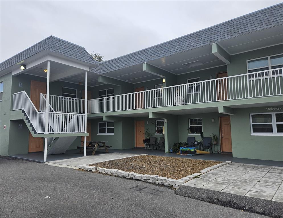 2045 Alpine Road, Unit 3 Clearwater, FL 33755 - Photo 2 of 18 a view of a house with a patio and a yard
