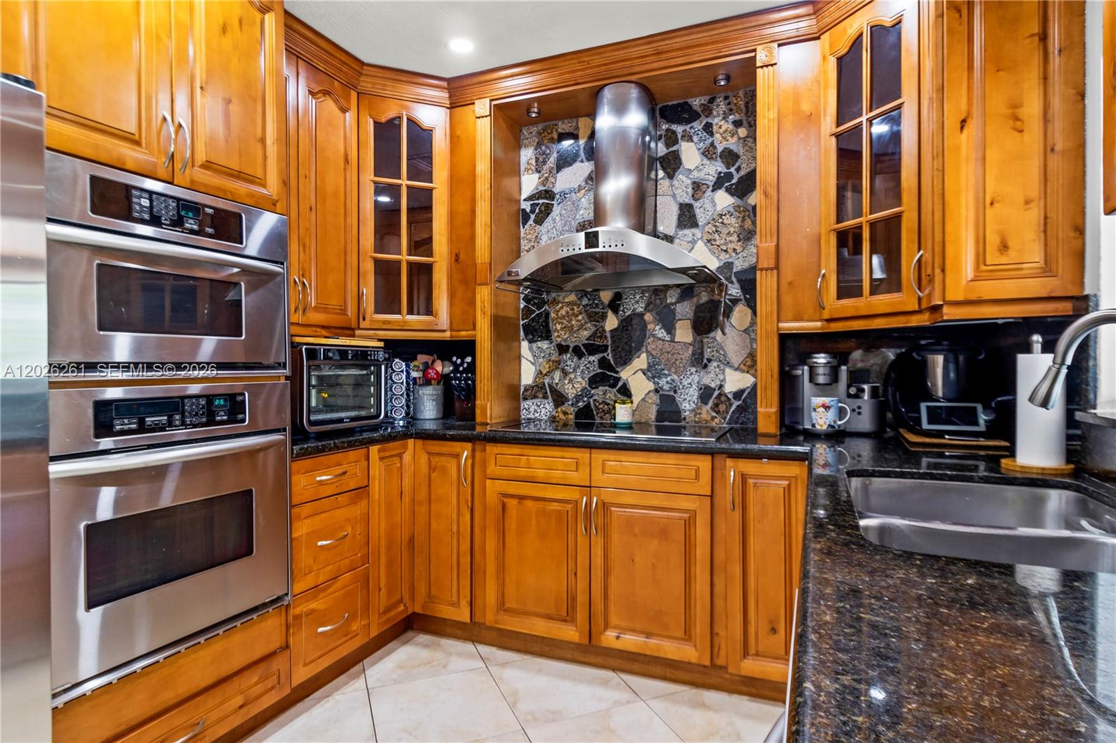 6250 Southwest 20th Terrace Miami, FL 33155 - Photo 5 of 42 a kitchen with stainless steel appliances granite countertop a stove and cabinets