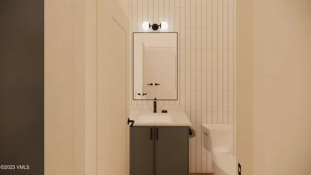 a bathroom with a sink and mirror