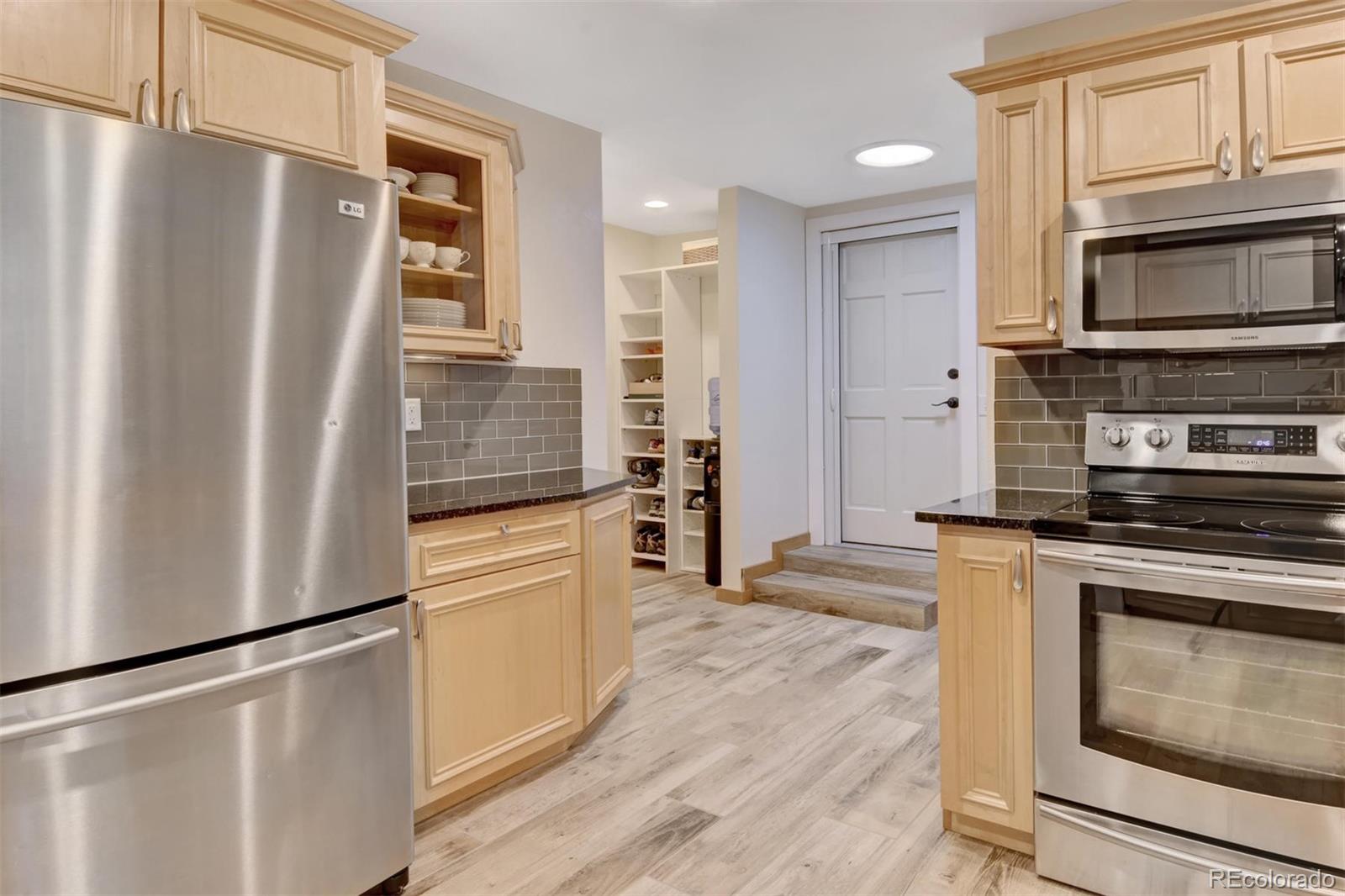 6761 Olde Stage Road Boulder, CO 80302 - Photo 12 of 36 a kitchen with stainless steel appliances a refrigerator stove and cabinets