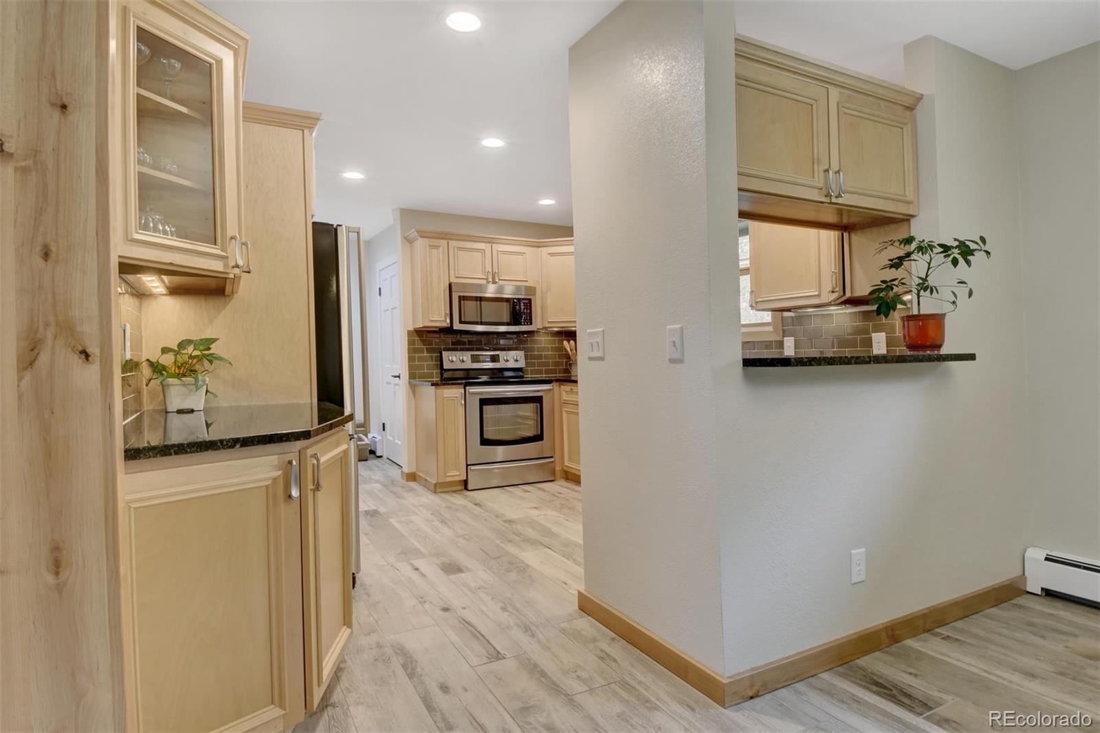 6761 Olde Stage Road Boulder, CO 80302 - Photo 14 of 36 a kitchen with stainless steel appliances a refrigerator and a stove top oven