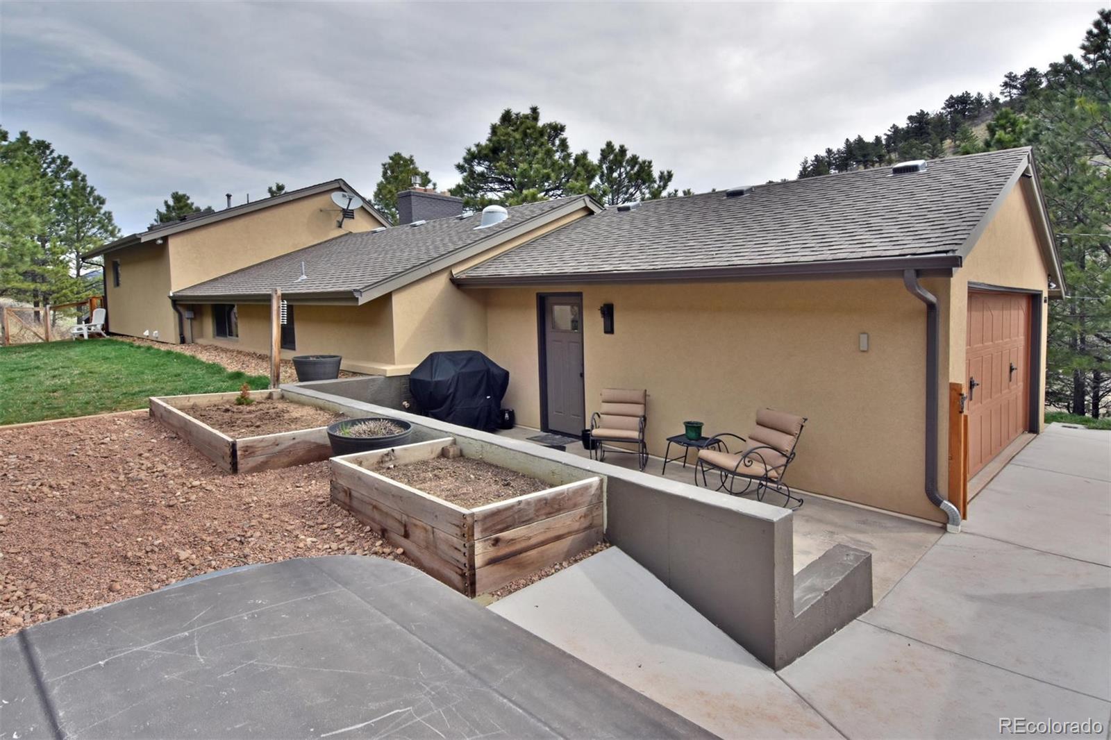 6761 Olde Stage Road Boulder, CO 80302 - Photo 2 of 36 a view of a house with backyard and a garden