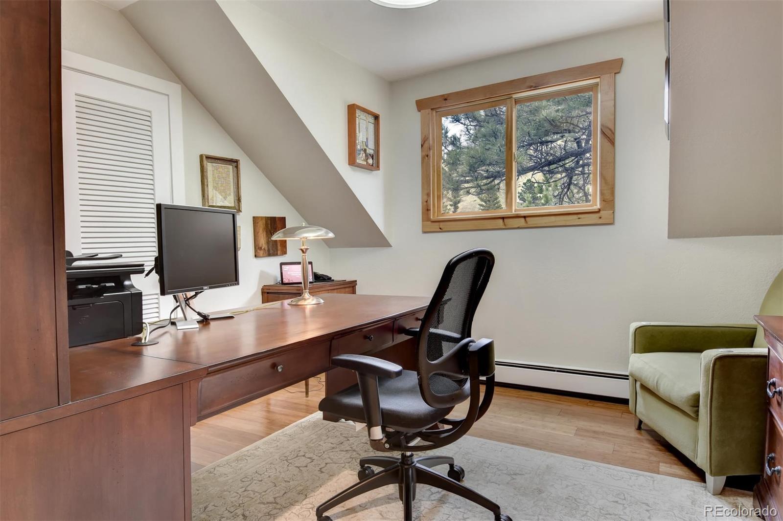 6761 Olde Stage Road Boulder, CO 80302 - Photo 23 of 36 a view of a workspace with furniture and a window
