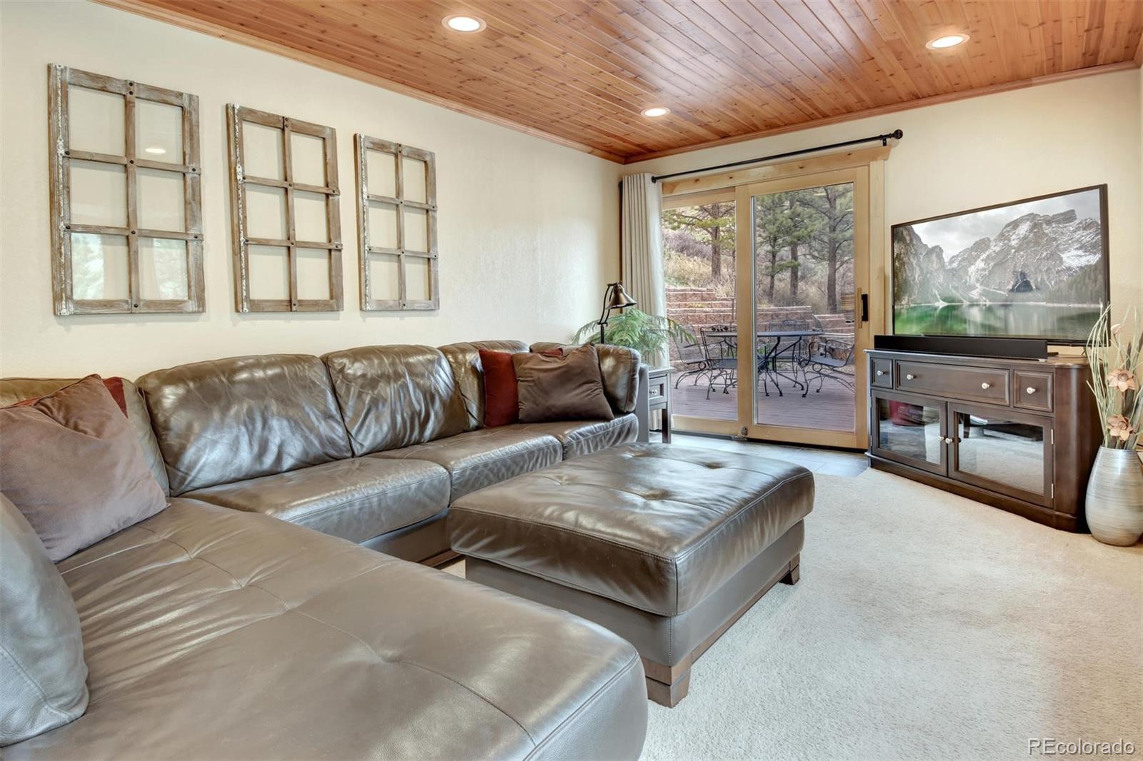 6761 Olde Stage Road Boulder, CO 80302 - Photo 27 of 36 a living room with furniture and a flat screen tv