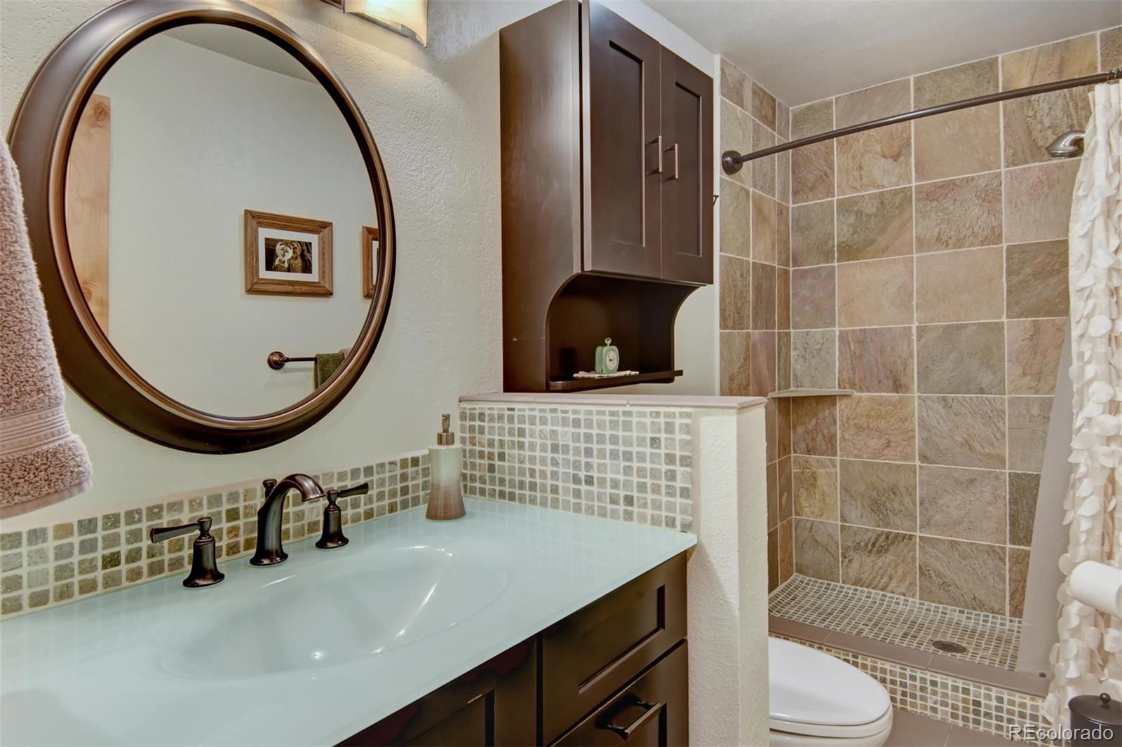 6761 Olde Stage Road Boulder, CO 80302 - Photo 29 of 36 a bathroom with a sink a mirror and a shower