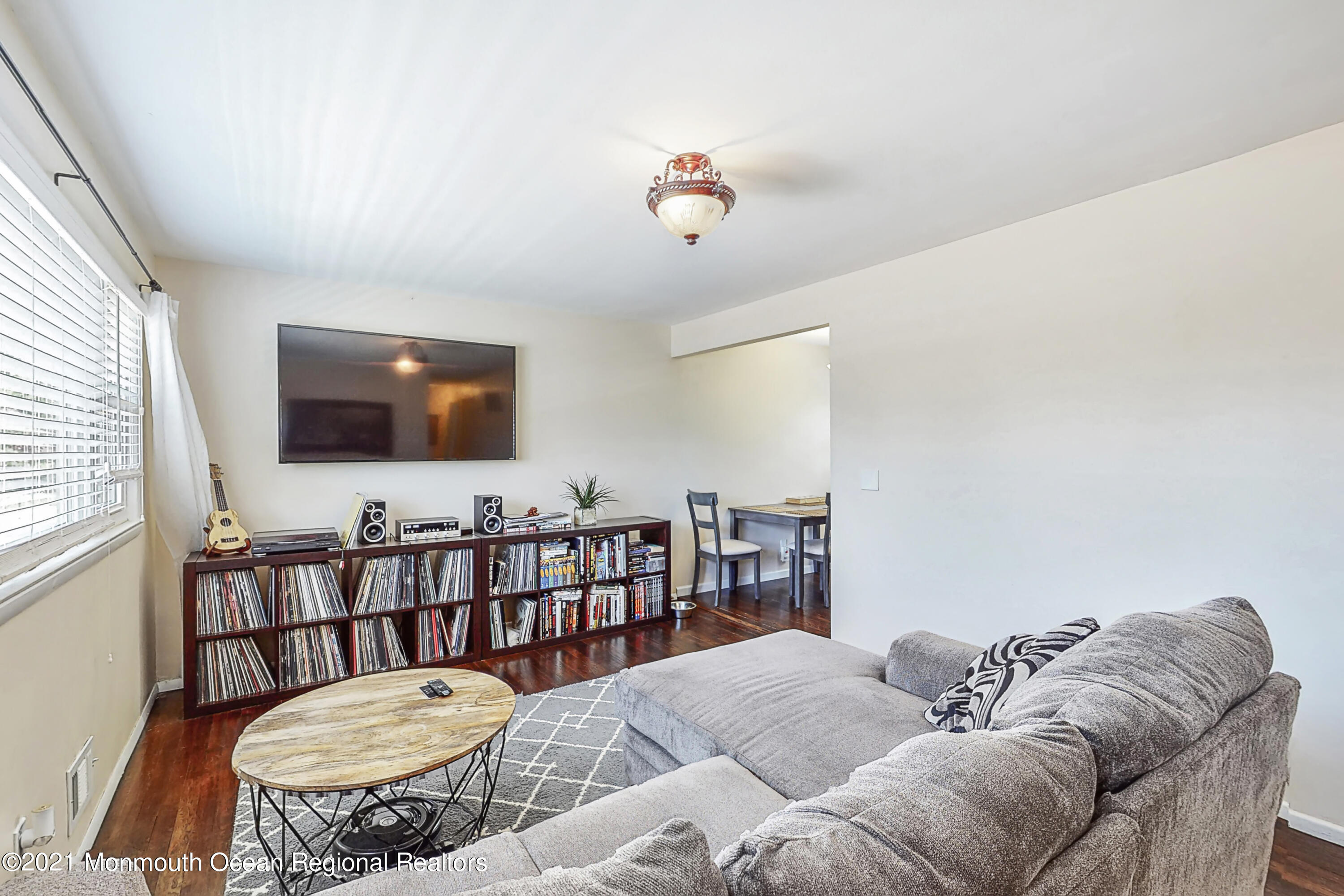 342 Stinson Road Brick, NJ 08723 - Photo 5 of 24 a living room with furniture a flat screen tv and a table