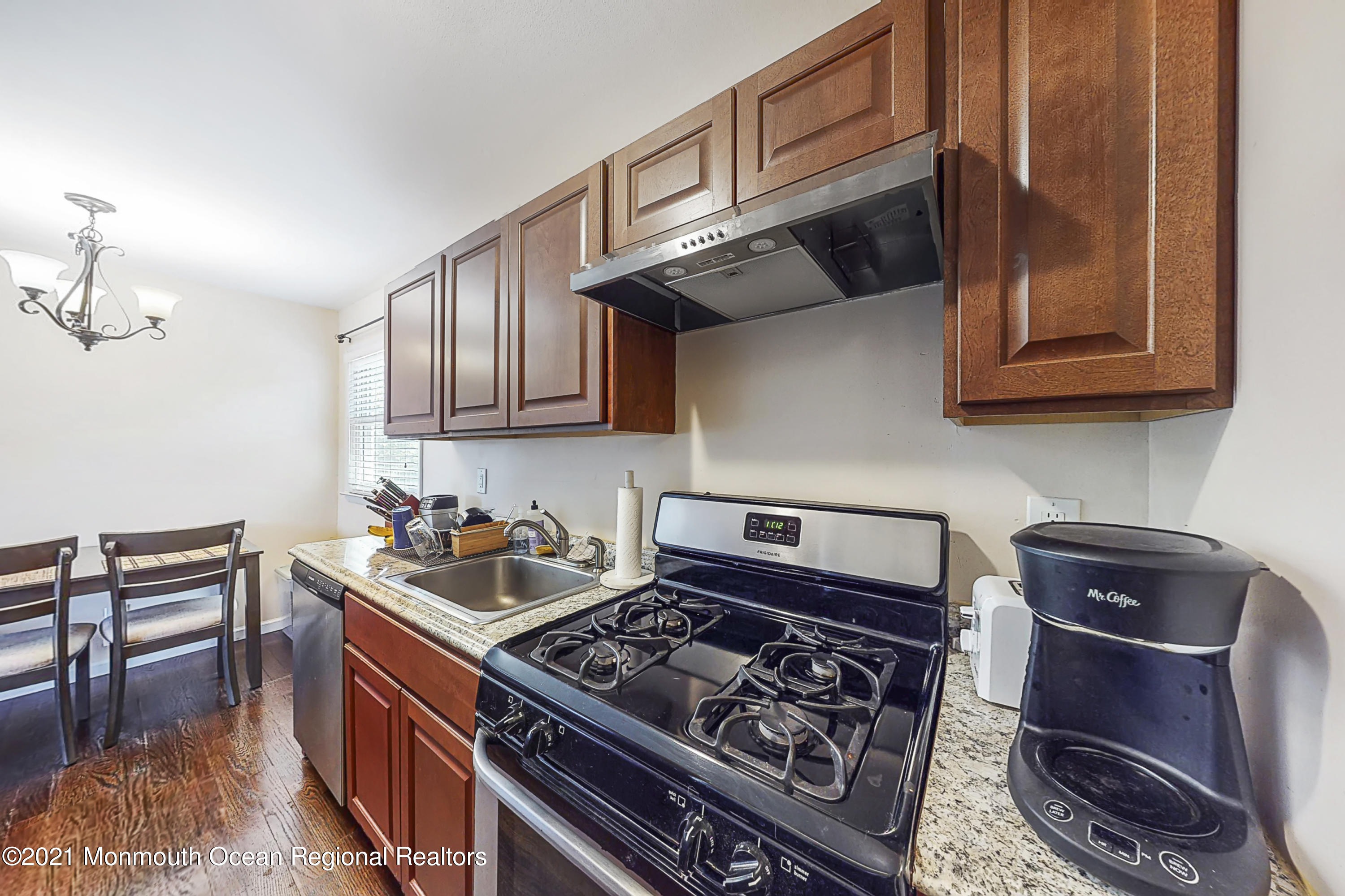 342 Stinson Road Brick, NJ 08723 - Photo 8 of 24 a kitchen with wooden cabinets and a stove top oven
