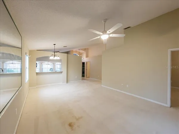 an empty room with a empty space and windows