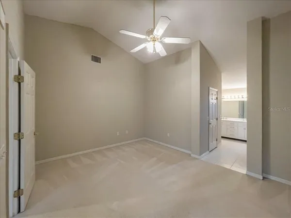 an empty room with a fan and a fan