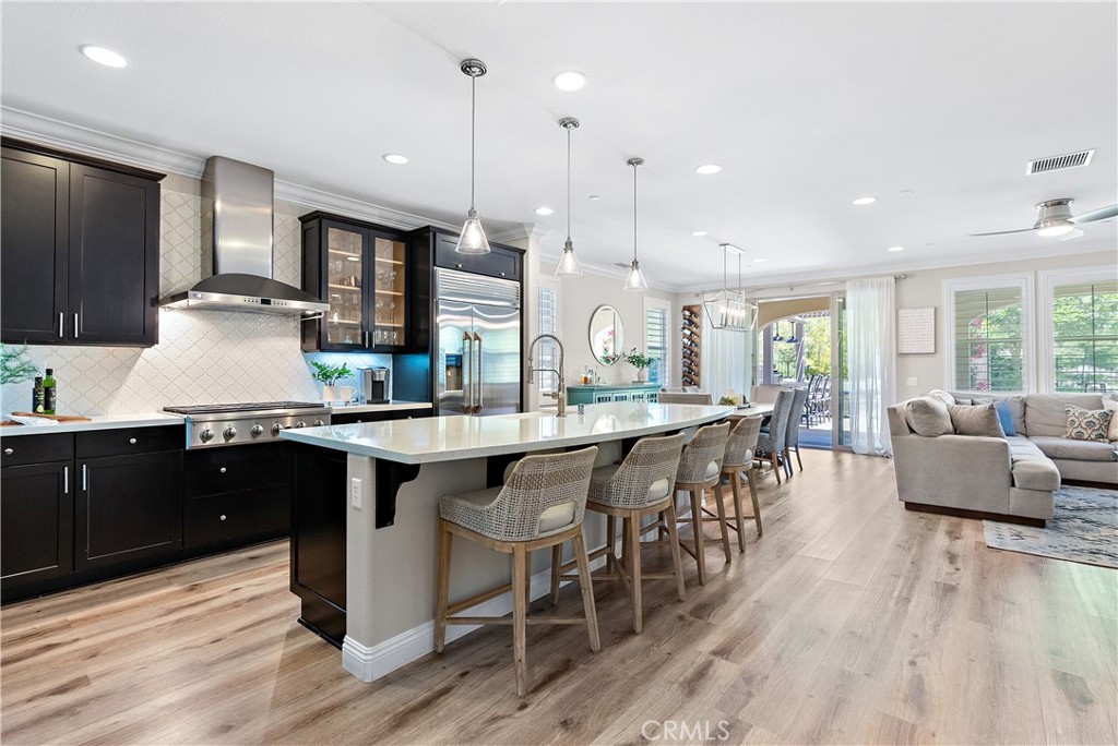 a large kitchen with lots of counter space dining table and stainless steel appliances