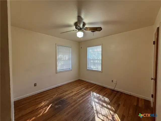 a view of room with window and ceiling fan