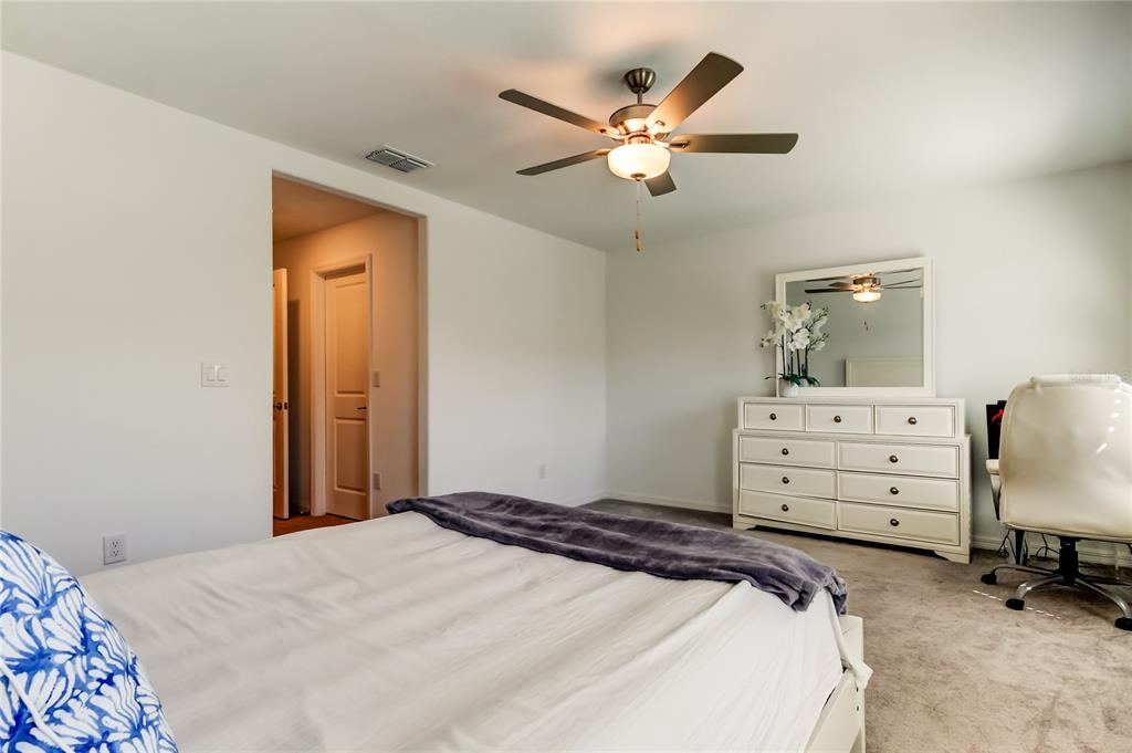 8294 Corner Pine Way New Port Richey, FL 34655 - Photo 45 of 55 a bedroom with a bed and a dresser