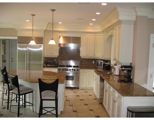 7 Old Barn Road Hanover, MA 02339 - Photo 3 of 14 a kitchen with stainless steel appliances kitchen island granite countertop a sink a stove a refrigerator cabinets and chairs