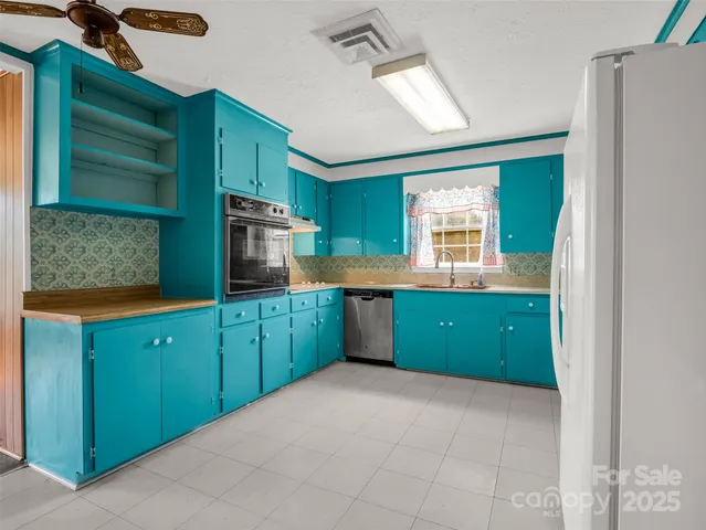 a kitchen with window and cabinets