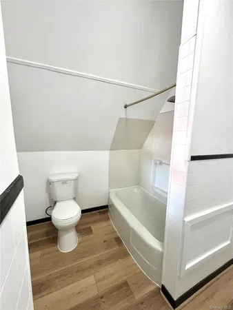 a white bath tub sitting next to a white sink and vanity