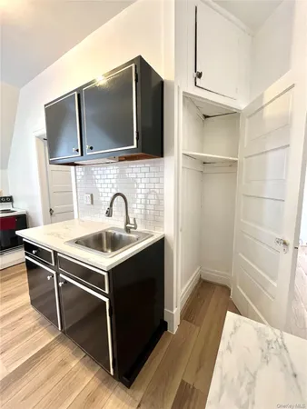 a view of a kitchen with microwave and cabinets