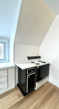 a view of room with window and wooden floor