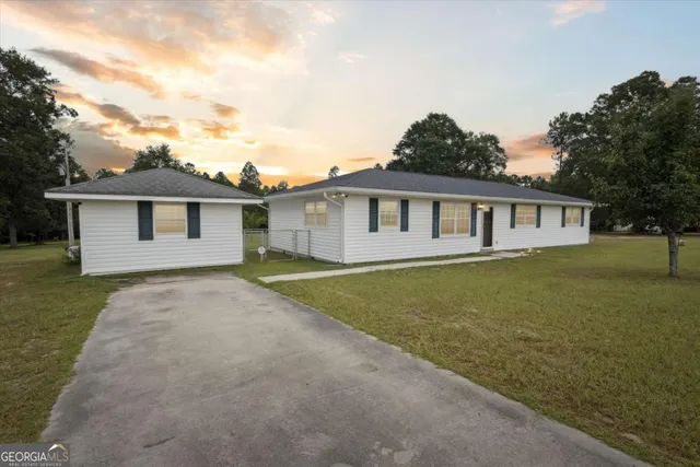 a view of a house with a garden and yard