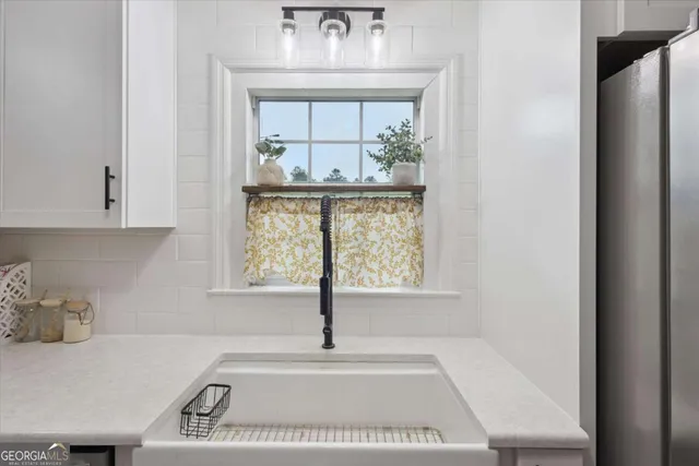 a bathroom with a tub sink and window