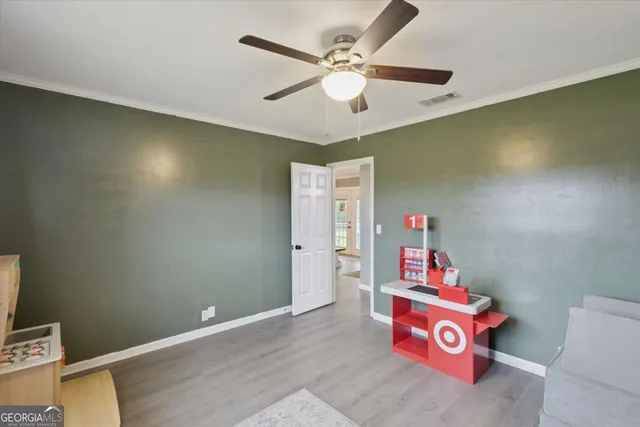 a view of a room with toys and a chandelier fan