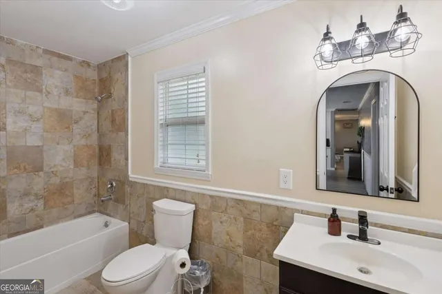 a bathroom with a toilet a sink and bathtub