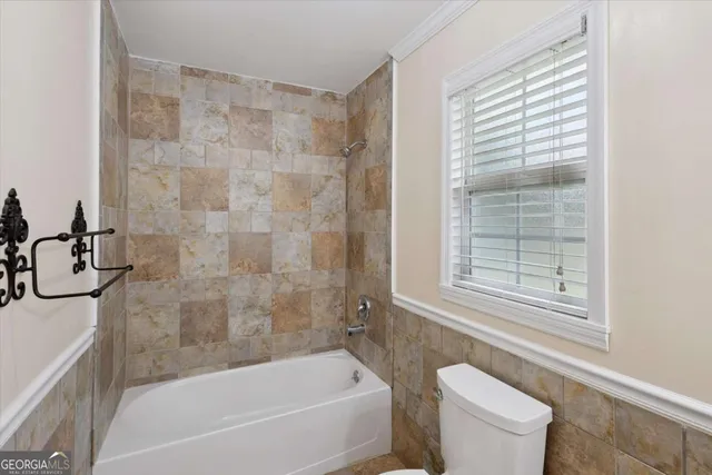 a bathroom with a bathtub and a toilet