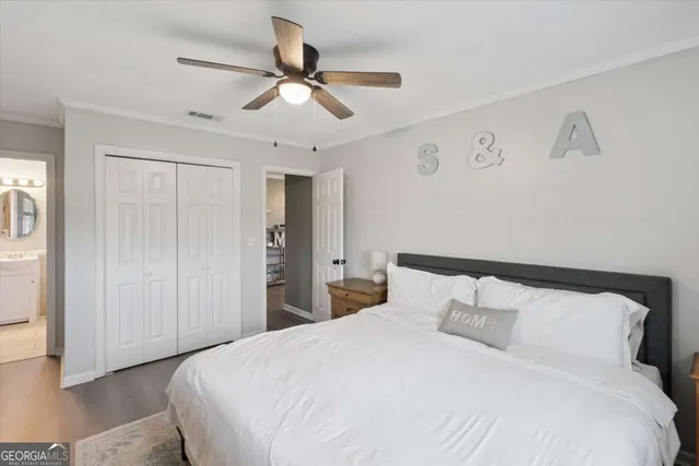 a bedroom with a large bed and a ceiling fan