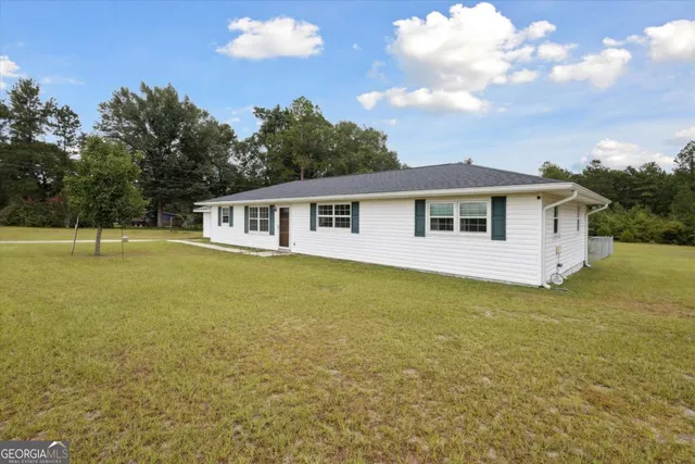 a view of a house with a backyard