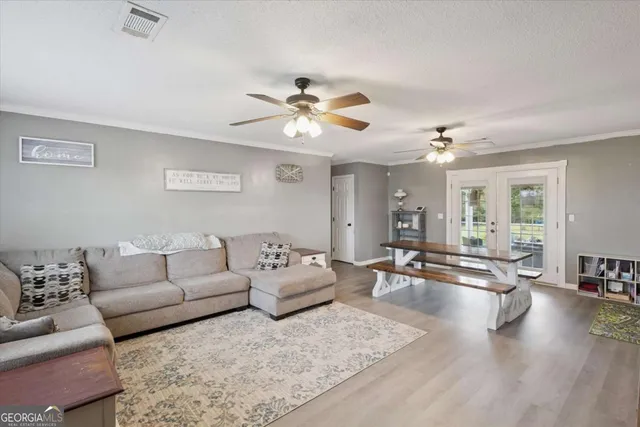 a living room with furniture ceiling fan and a rug