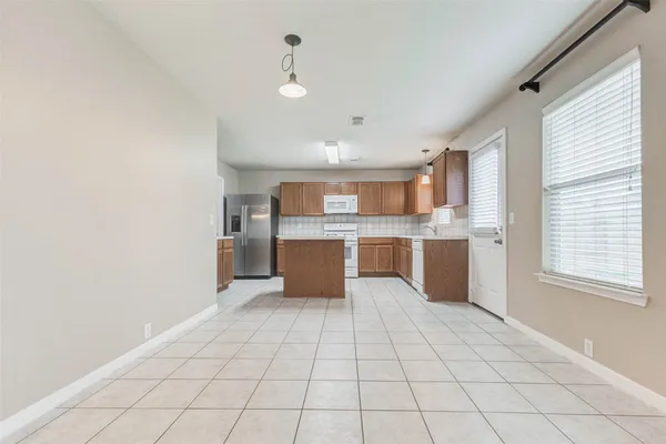 a large white kitchen with cabinets