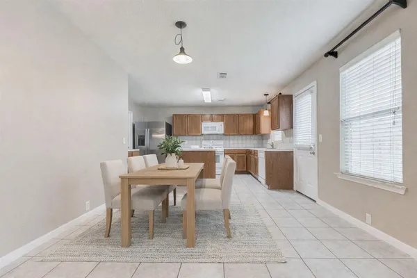 a dining room with furniture and window