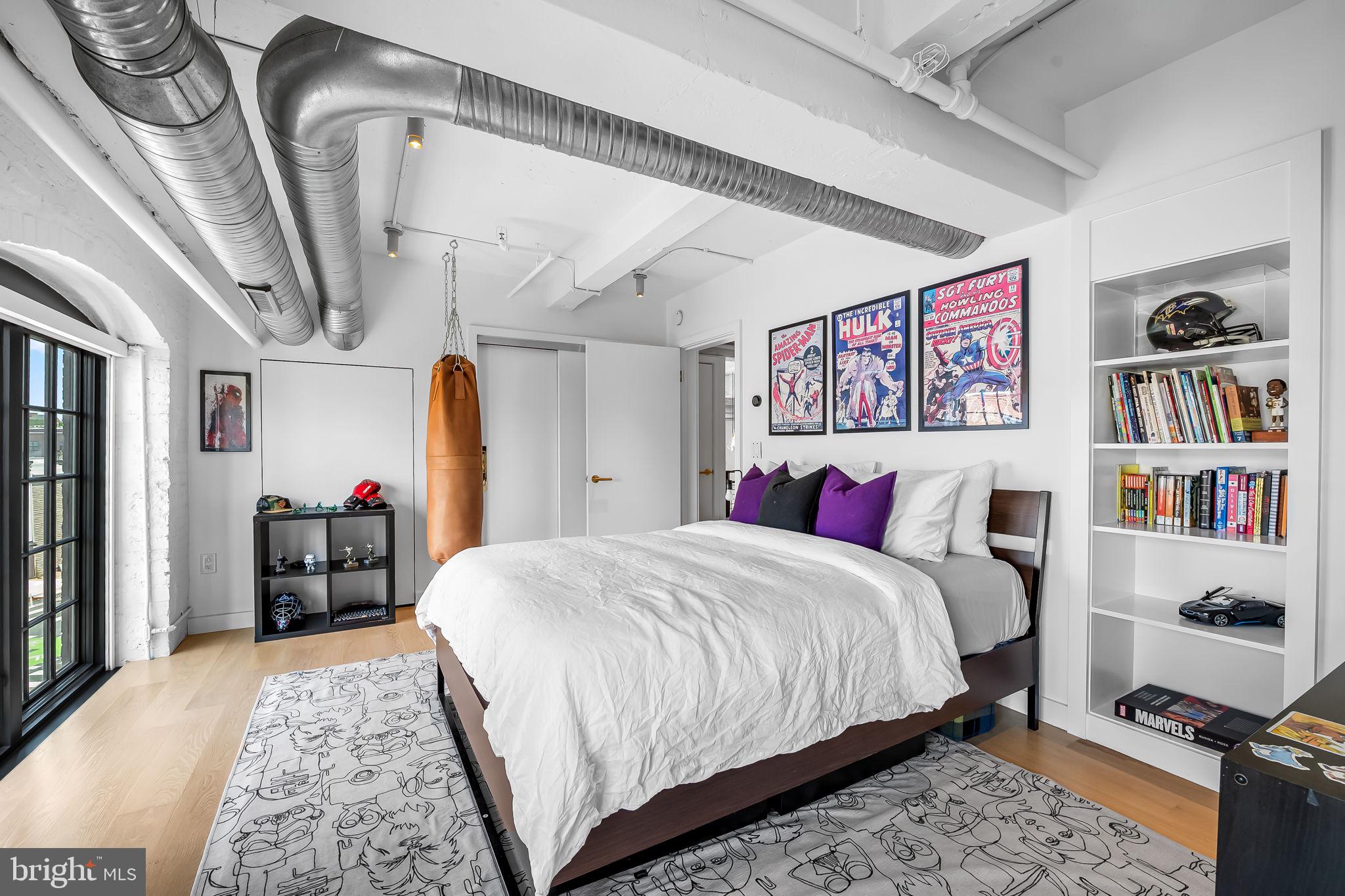 1220 Bank Street, Unit 304 Baltimore, MD 21202 - Photo 60 of 81 a bedroom with a large bed and a chandelier