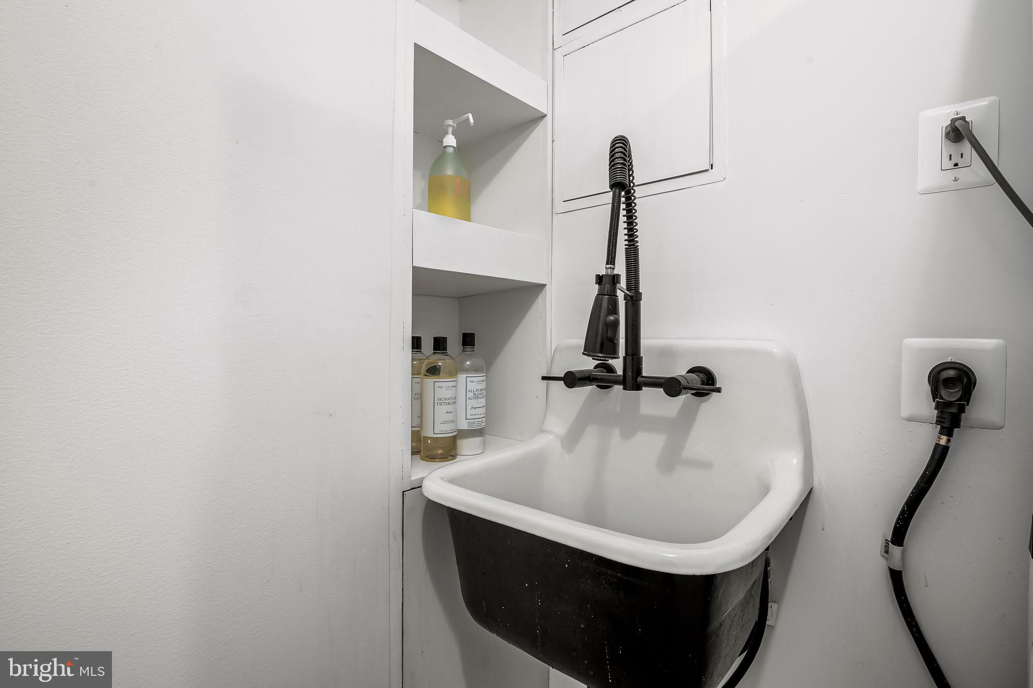 1220 Bank Street, Unit 304 Baltimore, MD 21202 - Photo 72 of 81 a bathroom with a sink and mirror